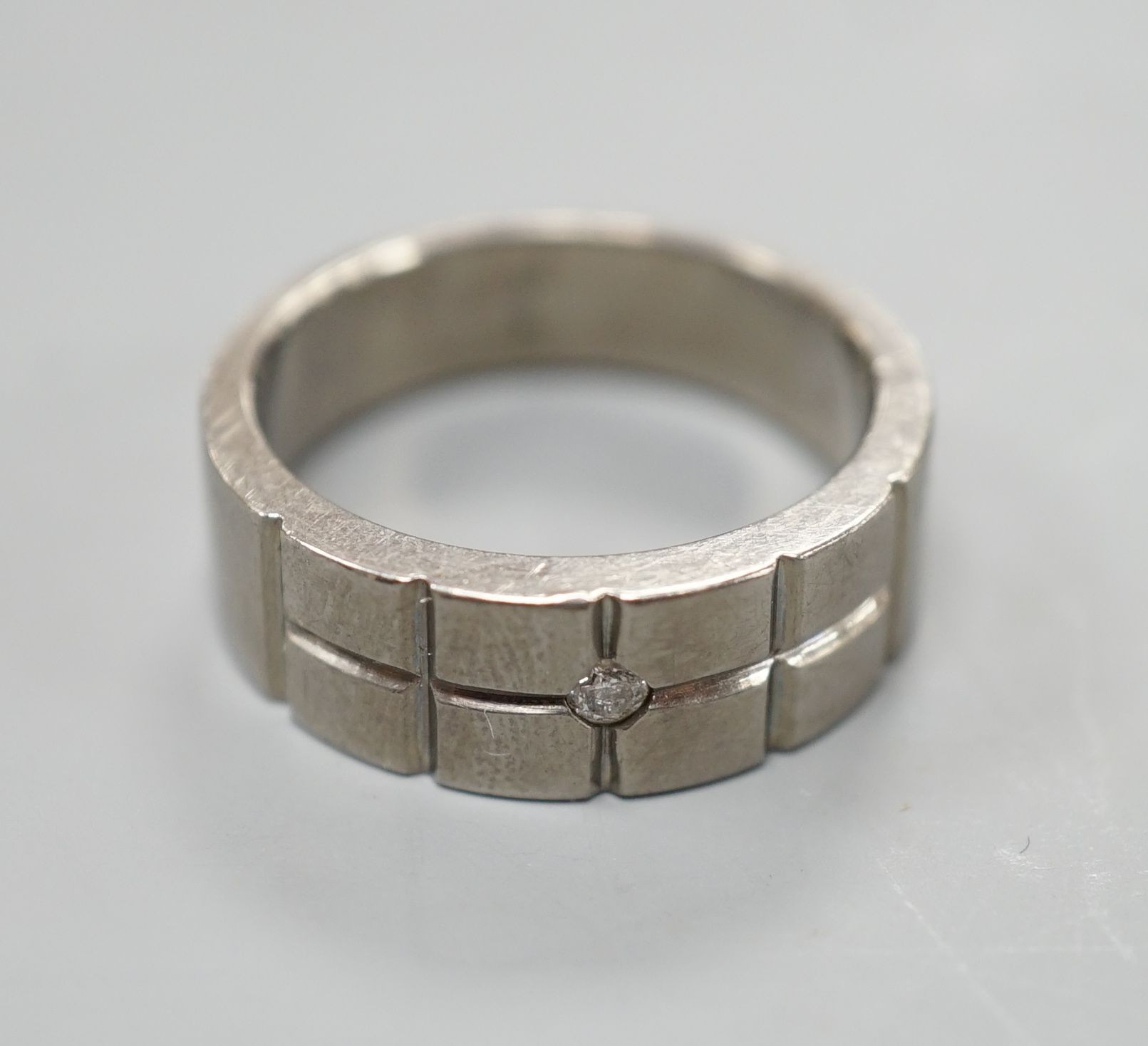 A diamond set titanium dress ring, size P, gross 3.3 grams